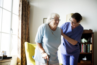 image Nurse helping senior woman to stand